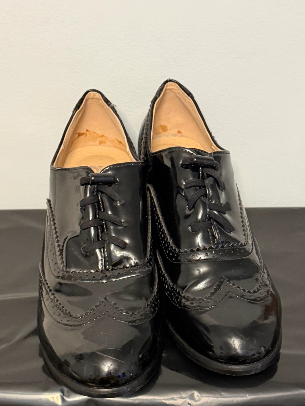 Women’s black Vegan Patent Wingtip heals
